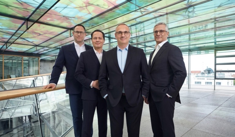 The SEFE Group Management Council standing together in a glass building. Board members representing leadership and responsibility in the energy sector.