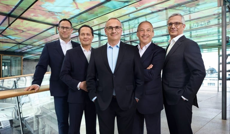 The SEFE Group Management Council standing together in a glass building – board members representing leadership and responsibility in the energy sector.